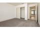 Bright bedroom features gray carpet, white walls, and sliding closet doors at 10309 Georgetown Pl, Las Vegas, NV 89134