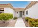 Inviting entrance with a charming green door and decorative shrubs lining the walkway at 10309 Georgetown Pl, Las Vegas, NV 89134