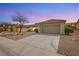 Attractive single-story home with a tile roof, desert landscaping, and a spacious driveway at 10309 Georgetown Pl, Las Vegas, NV 89134