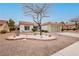 Single-story home with a desert landscape featuring a unique rock and succulent garden at 10309 Georgetown Pl, Las Vegas, NV 89134