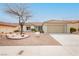 Charming single-story home with a well-manicured desert landscape and neutral color scheme at 10309 Georgetown Pl, Las Vegas, NV 89134