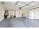 Spacious garage with painted floor, ample storage space, and white refrigerator at 10309 Georgetown Pl, Las Vegas, NV 89134