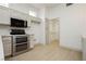 Modern kitchen equipped with stainless steel appliances and light wood flooring at 10309 Georgetown Pl, Las Vegas, NV 89134