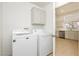 Laundry room with washer and dryer, cabinets, and tile flooring at 10309 Georgetown Pl, Las Vegas, NV 89134