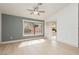 Bright living room featuring a large window, light wood floors, and neutral gray accents at 10309 Georgetown Pl, Las Vegas, NV 89134