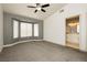 Spacious main bedroom featuring a ceiling fan, bay windows, and an en suite bathroom at 10309 Georgetown Pl, Las Vegas, NV 89134