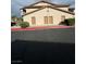 Building featuring a low-pitch roof and tan exterior with four entrance doors and nearby parking at 1320 Driscoll Dr # 202, Las Vegas, NV 89128