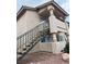 Beige apartment building with stairs leading to a balcony; natural light and modern architecture at 1320 Driscoll Dr # 202, Las Vegas, NV 89128
