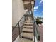 Exterior stairs leading to an apartment entrance, surrounded by desert landscaping and clear blue skies at 1320 Driscoll Dr # 202, Las Vegas, NV 89128