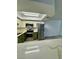 Well-lit kitchen boasts stainless steel appliances, quartz countertops, and a convenient breakfast bar at 1320 Driscoll Dr # 202, Las Vegas, NV 89128