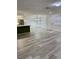 Open floor plan showcasing the living room with modern floors and the kitchen in the background at 1320 Driscoll Dr # 202, Las Vegas, NV 89128
