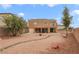 Spacious backyard featuring gravel landscaping, covered patio, and an outdoor seating area at 1405 Peyton Stewart Ct, North Las Vegas, NV 89086