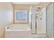 Well-lit bathroom featuring a separate soaking tub and glass shower at 1405 Peyton Stewart Ct, North Las Vegas, NV 89086