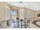 Cozy breakfast nook with a glass table, chairs, and views of the outdoor patio at 1405 Peyton Stewart Ct, North Las Vegas, NV 89086