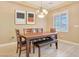 Well-lit dining room featuring a wooden table set, stylish lighting, and neutral wall color at 1405 Peyton Stewart Ct, North Las Vegas, NV 89086