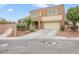 Charming exterior showcasing a two-story home with a spacious driveway and desert landscaping at 1405 Peyton Stewart Ct, North Las Vegas, NV 89086