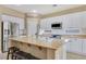 Spacious kitchen showcases white cabinetry, granite countertops, stainless steel appliances and a center island at 1405 Peyton Stewart Ct, North Las Vegas, NV 89086