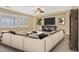 Comfortable living room with a sectional sofa, plantation shutters, and entertainment center at 1405 Peyton Stewart Ct, North Las Vegas, NV 89086