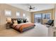 Bright main bedroom with plush carpeting, stylish furnishings, and a sliding glass door at 1405 Peyton Stewart Ct, North Las Vegas, NV 89086