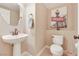 Chic powder room features a pedestal sink, toilet, and stylish decor at 1405 Peyton Stewart Ct, North Las Vegas, NV 89086