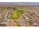 Aerial view of a home and surrounding neighborhood with a golf course at 1510 Fieldbrook St, Henderson, NV 89052