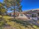 A spacious backyard with lush green grass, mature trees, and a covered patio at 1510 Fieldbrook St, Henderson, NV 89052
