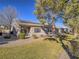 Backyard with a touch of green grass, desert landscaping, and solar panels on the roof at 1510 Fieldbrook St, Henderson, NV 89052