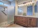 Modern bathroom featuring a double sink vanity with wood cabinets and a glass enclosed shower at 1510 Fieldbrook St, Henderson, NV 89052
