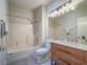 Updated bathroom featuring a vanity with wood cabinets, a shower-tub combo, and modern fixtures at 1510 Fieldbrook St, Henderson, NV 89052