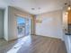 Dining area featuring modern lighting, new flooring, and sliding glass doors at 1510 Fieldbrook St, Henderson, NV 89052