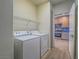 Laundry room featuring white washer and dryer and metal shelving at 1510 Fieldbrook St, Henderson, NV 89052