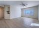 Bright living room with new flooring, a ceiling fan, and a large window at 1510 Fieldbrook St, Henderson, NV 89052