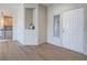 Hallway to the living room featuring hardwood style floors, view of kitchen, and front door at 1510 Fieldbrook St, Henderson, NV 89052