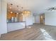 Open-concept living room featuring hardwood flooring, contemporary lighting, and a seamless flow into the kitchen at 1510 Fieldbrook St, Henderson, NV 89052
