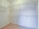Walk-in closet with metal shelving and hardwood floors at 1510 Fieldbrook St, Henderson, NV 89052