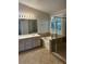 Bathroom showcasing a double sink vanity, soaking tub, and glass-enclosed shower at 1782 Castro Hill Ave, Henderson, NV 89012