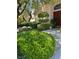 Professionally landscaped front yard with a tiered tree and lush green shrubs leading to the front door at 1782 Castro Hill Ave, Henderson, NV 89012