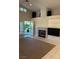 Bright living room with fireplace, built-in cabinets, and French doors that lead to the backyard at 1782 Castro Hill Ave, Henderson, NV 89012