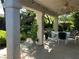 Inviting covered patio with ceiling fans, outdoor lighting, dining table, and lush garden views at 1782 Castro Hill Ave, Henderson, NV 89012