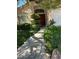 Stone walkway leading to the front door, flanked by manicured greenery, enhances curb appeal at 1782 Castro Hill Ave, Henderson, NV 89012