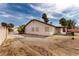 Rear exterior view with a long driveway, stucco siding and large backyard with a covered patio area at 1816 Mazzanti Way, Henderson, NV 89014