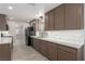 Well-lit kitchen features modern countertops, stainless steel appliances, and wood-look flooring at 1816 Mazzanti Way, Henderson, NV 89014