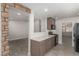 Open-concept kitchen with modern appliances, stone details, and seamless flow to living area at 1816 Mazzanti Way, Henderson, NV 89014