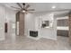 Spacious living area featuring stone accents, fireplace, modern lighting, and wood-look flooring at 1816 Mazzanti Way, Henderson, NV 89014