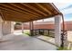 Covered patio featuring a concrete floor, wood ceiling, and decorative wood and stone railing at 1816 Mazzanti Way, Henderson, NV 89014