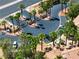 Aerial view of community gate, palm trees, nearby parking and condo buildings with red tile roofs at 1830 N Buffalo Dr # 2014, Las Vegas, NV 89128