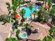 Aerial view of the community pool and hot tub, palm trees and nearby condo buildings with red tile roofs at 1830 N Buffalo Dr # 2014, Las Vegas, NV 89128