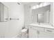 Clean bathroom features white vanity, sink, and toilet plus a mirror at 1830 N Buffalo Dr # 2014, Las Vegas, NV 89128