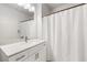 Bathroom features vanity with solid surface counter and shower with curtain at 1830 N Buffalo Dr # 2014, Las Vegas, NV 89128