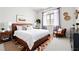 Well-furnished bedroom with a leather frame bed, plants, and a modern dresser at 1830 N Buffalo Dr # 2014, Las Vegas, NV 89128
